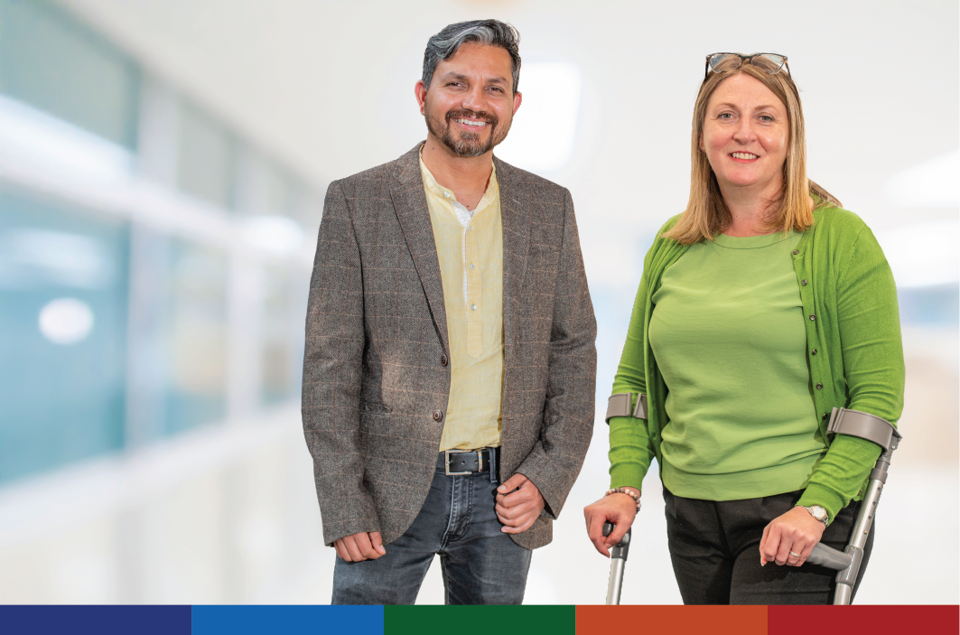 Image of two staff members standing together and smiling.